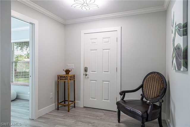 sitting room with light hardwood / wood-style flooring and crown molding