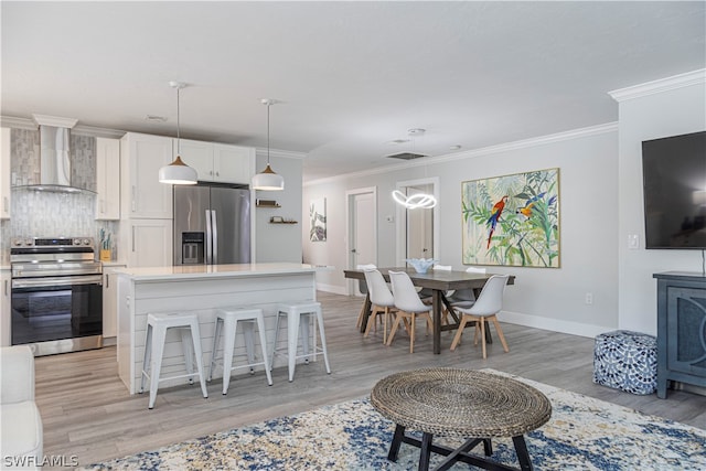 kitchen featuring stainless steel refrigerator with ice dispenser, wall chimney range hood, light hardwood / wood-style floors, electric range, and white cabinets