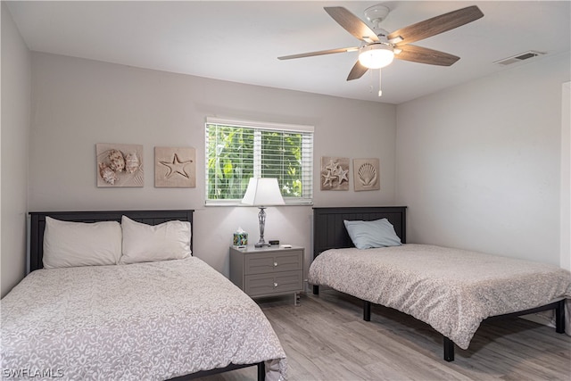 bedroom featuring light wood-type flooring and ceiling fan