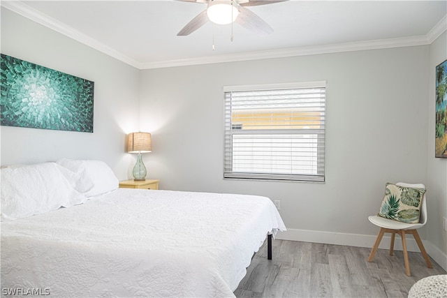 bedroom featuring ornamental molding, ceiling fan, and hardwood / wood-style floors