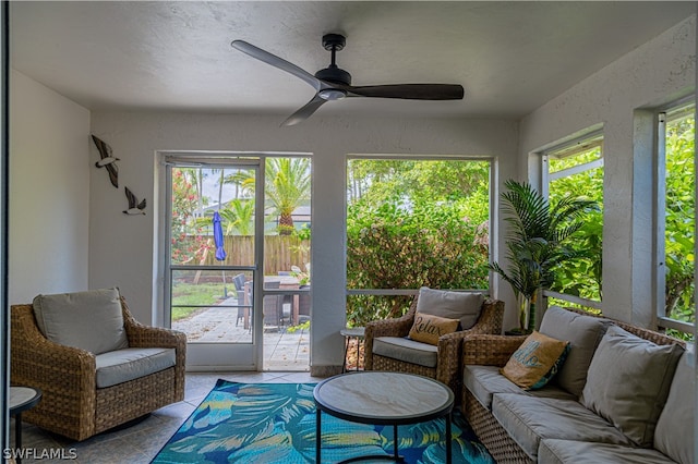 sunroom / solarium featuring plenty of natural light and ceiling fan