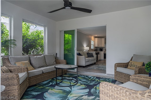 living room featuring ceiling fan and hardwood / wood-style floors