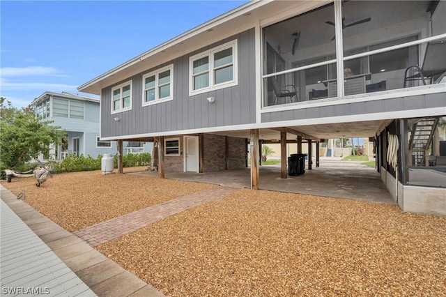 coastal home with a carport and a sunroom