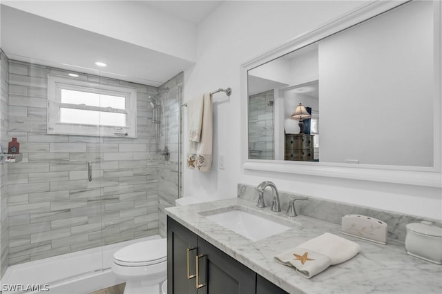 bathroom featuring vanity, toilet, and an enclosed shower