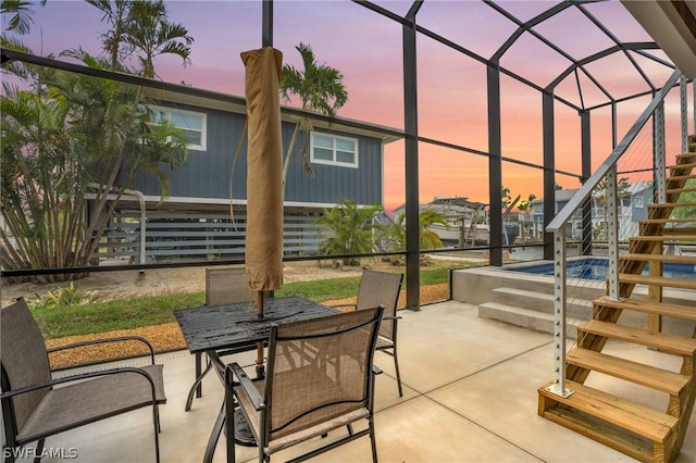 view of patio / terrace with glass enclosure, stairs, and outdoor dining space