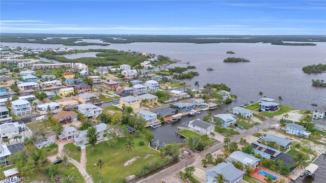 birds eye view of property featuring a water view and a residential view