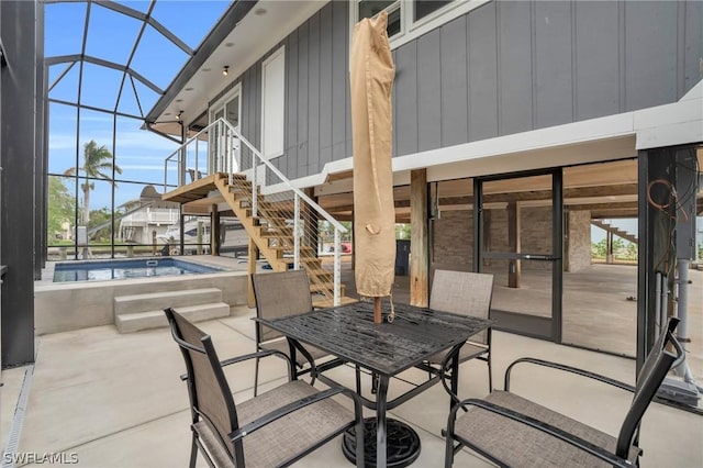 view of patio featuring a lanai