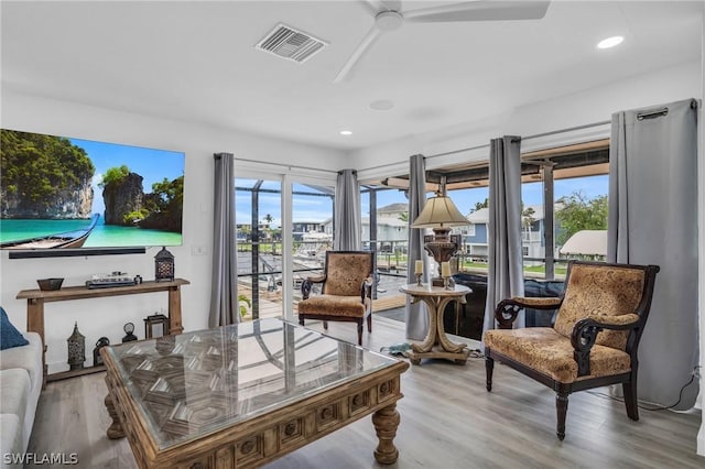 interior space with recessed lighting, visible vents, a wealth of natural light, and wood finished floors