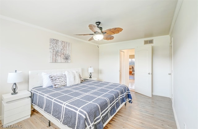 bedroom featuring ceiling fan, light hardwood / wood-style flooring, and ornamental molding