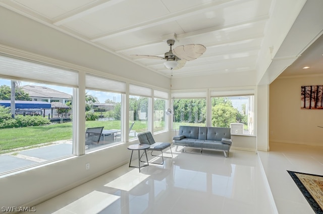 sunroom featuring ceiling fan