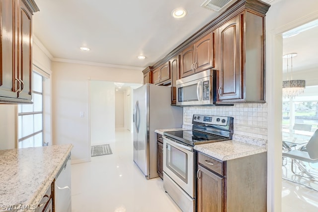 kitchen featuring tasteful backsplash, stainless steel appliances, light tile patterned floors, light stone countertops, and ornamental molding