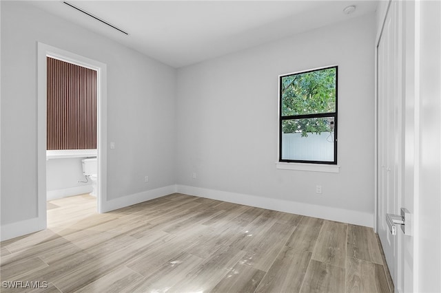 empty room with light hardwood / wood-style floors