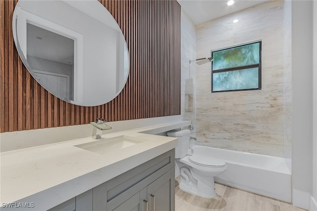 full bathroom with vanity, toilet, and tiled shower / bath