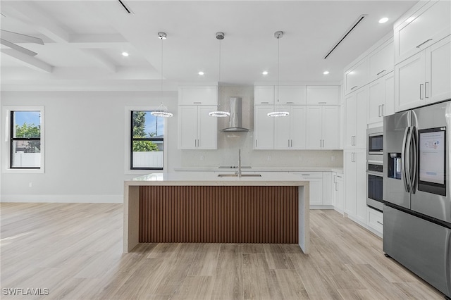 kitchen with wall chimney range hood, white cabinets, stainless steel appliances, and light wood-type flooring