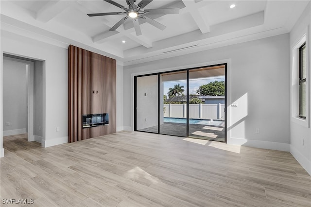 interior space with a fireplace, light hardwood / wood-style flooring, beam ceiling, and ceiling fan