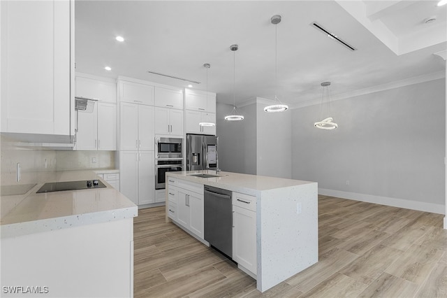 kitchen featuring an island with sink, hanging light fixtures, appliances with stainless steel finishes, white cabinets, and light hardwood / wood-style floors