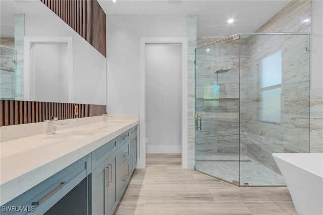 bathroom featuring shower with separate bathtub and vanity