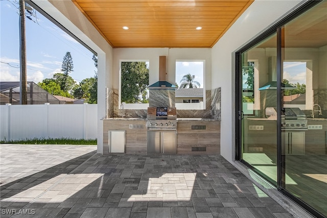 view of patio featuring an outdoor kitchen and sink