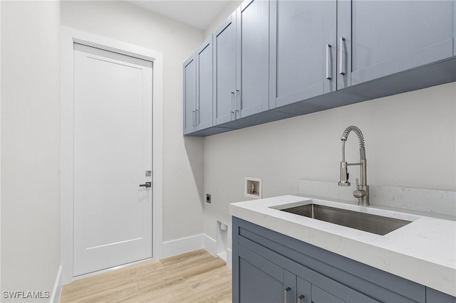 689 101st Ave N, Naples, FL 34108 - laundry area featuring hookup for an electric dryer, washer hookup, light wood-type flooring, cabinet space, and baseboards