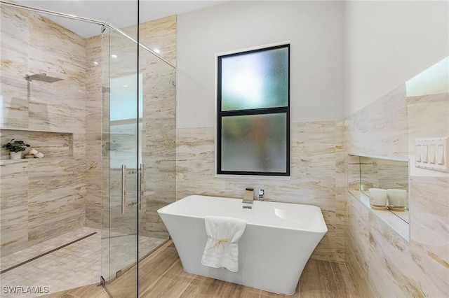 689 101st Ave N, Naples, FL 34108 - bathroom featuring tile walls, a tile shower, and a soaking tub