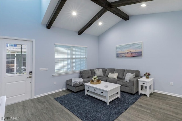 living room featuring dark hardwood / wood-style flooring, lofted ceiling with beams, and a healthy amount of sunlight