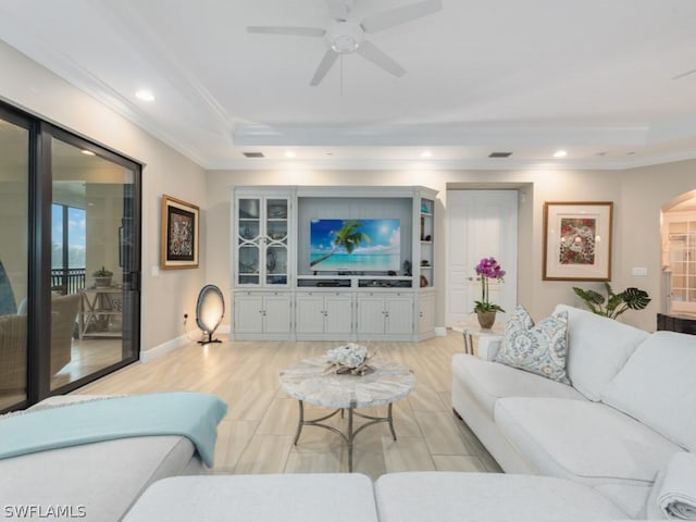 living room with ceiling fan, light wood-type flooring, and ornamental molding