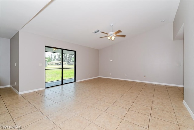 unfurnished room with ceiling fan, light tile patterned floors, and vaulted ceiling