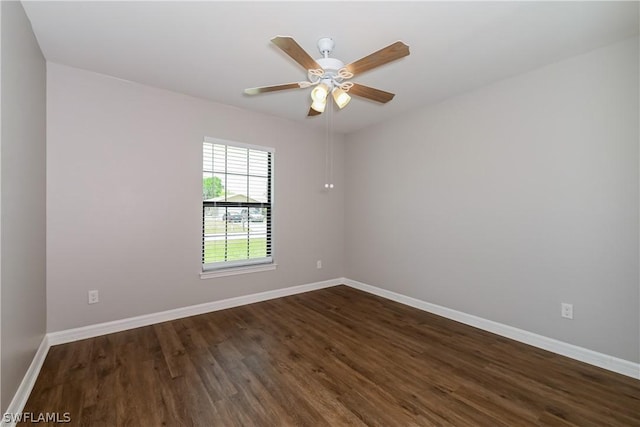 spare room with ceiling fan and dark wood-type flooring