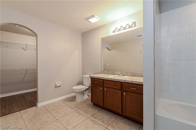 bathroom with tile patterned flooring, vanity, and toilet