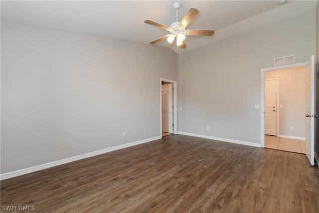 unfurnished room featuring ceiling fan, dark hardwood / wood-style flooring, and lofted ceiling