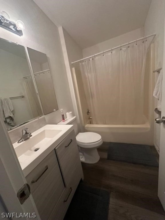 full bathroom featuring hardwood / wood-style flooring, vanity, shower / bath combo, and toilet