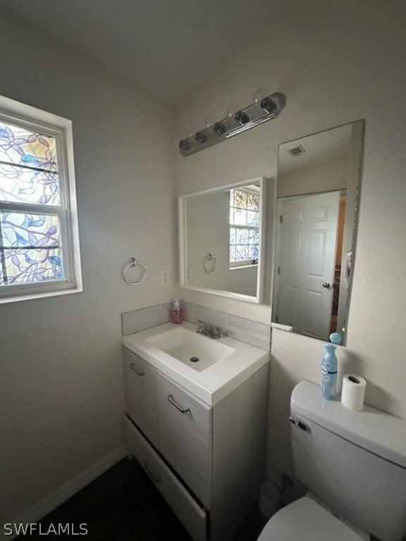 bathroom featuring vanity and toilet