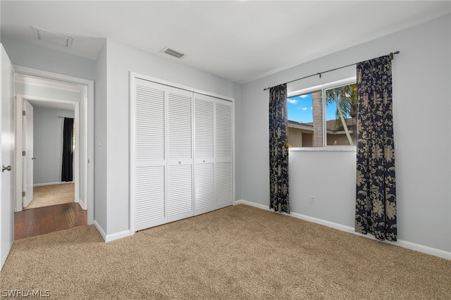 unfurnished bedroom with carpet and a closet