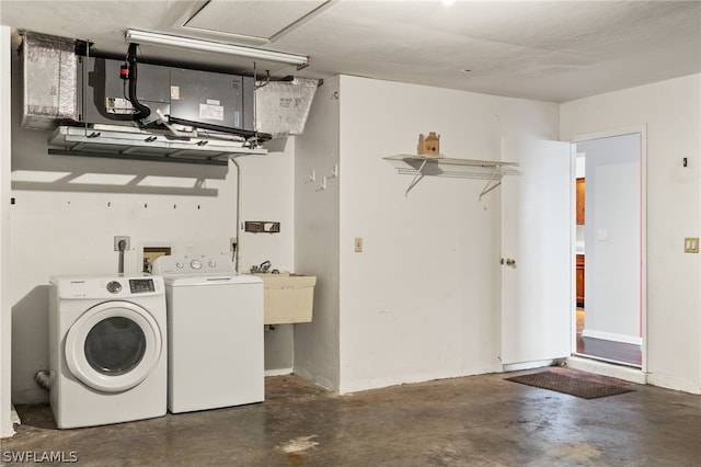 laundry area featuring sink and separate washer and dryer