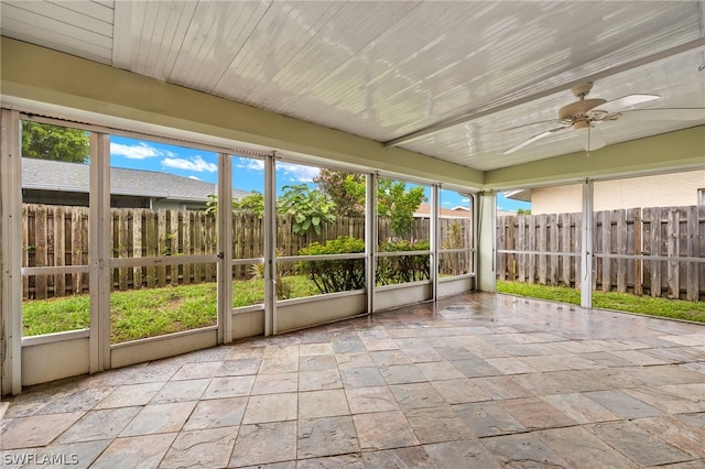 unfurnished sunroom featuring wooden ceiling and ceiling fan