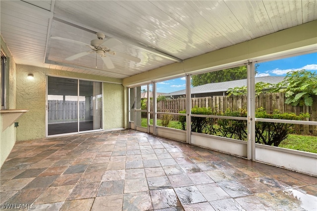 unfurnished sunroom featuring ceiling fan and wooden ceiling