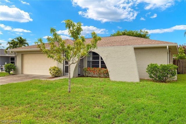 view of front of house with a garage and a front yard