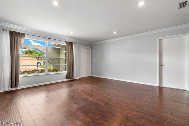 empty room with dark wood-type flooring and ornamental molding