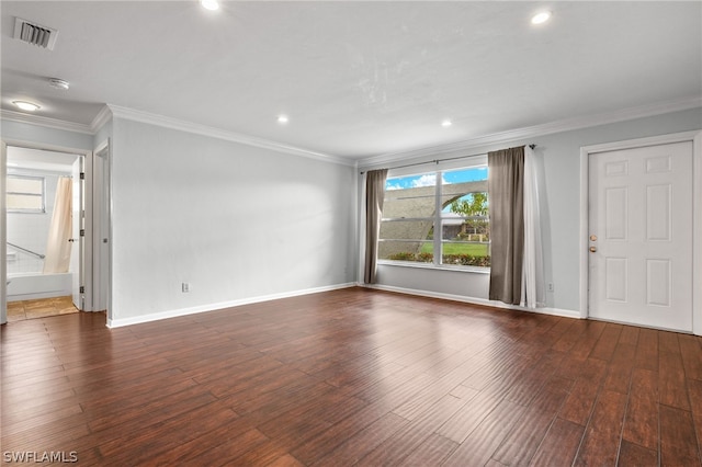 unfurnished living room featuring ornamental molding and dark wood-type flooring