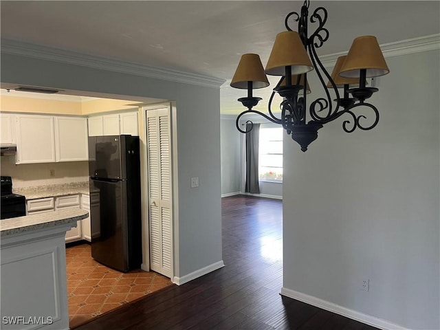 kitchen featuring crown molding, black appliances, white cabinets, and range hood