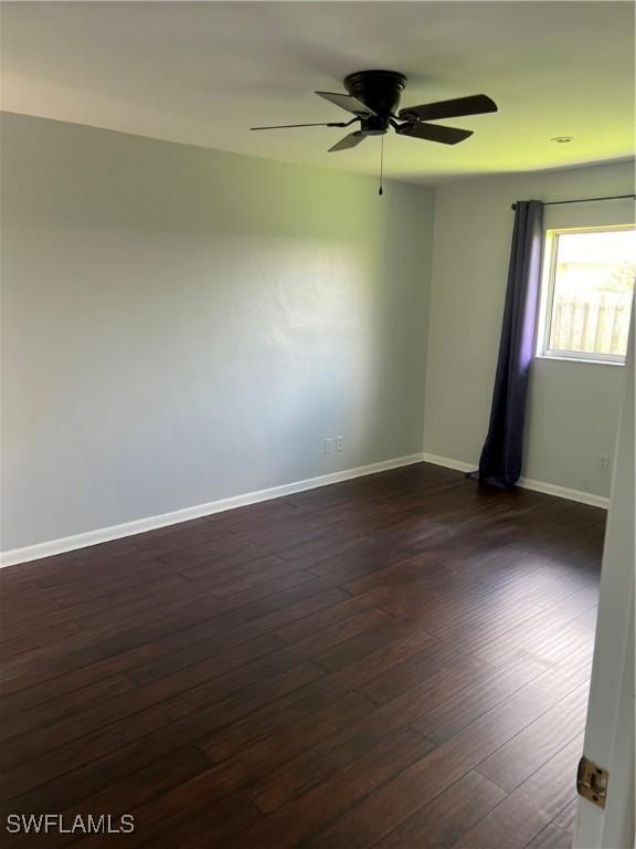 unfurnished room featuring ceiling fan and dark hardwood / wood-style floors