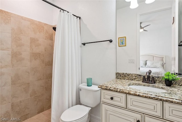 bathroom featuring toilet, ceiling fan, walk in shower, and vanity