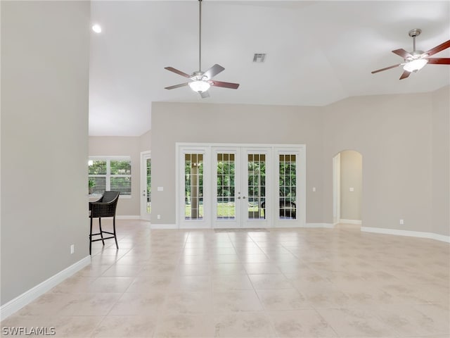 unfurnished living room featuring french doors, light tile patterned floors, and ceiling fan