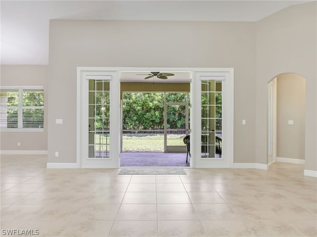 entryway with light tile patterned floors and ceiling fan