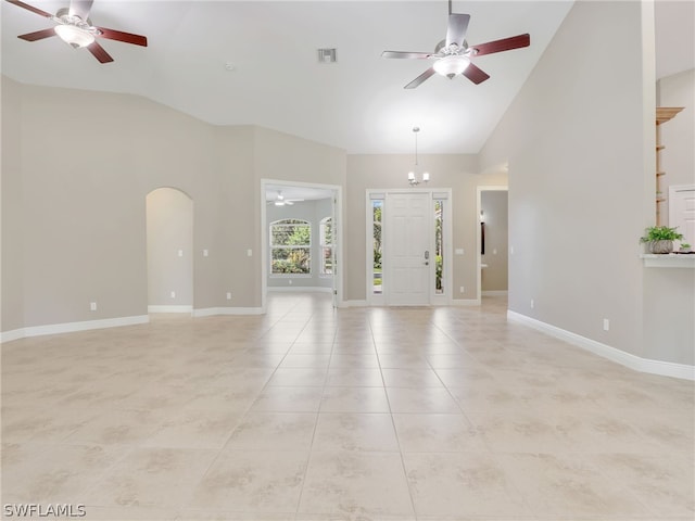 unfurnished living room with light tile patterned floors and vaulted ceiling