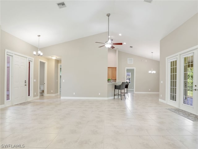 unfurnished living room featuring light tile patterned floors, ceiling fan with notable chandelier, and high vaulted ceiling