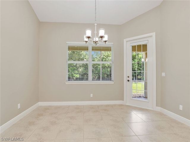 unfurnished dining area with a notable chandelier and light tile patterned flooring