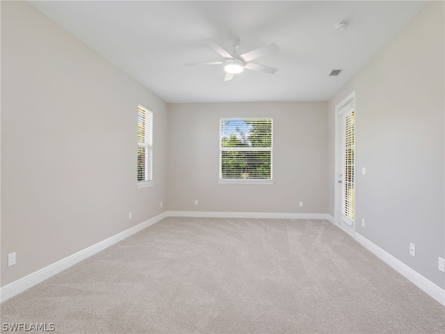 empty room featuring light carpet and ceiling fan