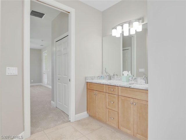 bathroom with tile patterned flooring and vanity