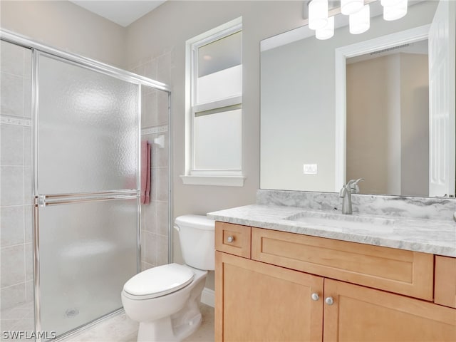 bathroom with tile patterned flooring, vanity, toilet, and walk in shower